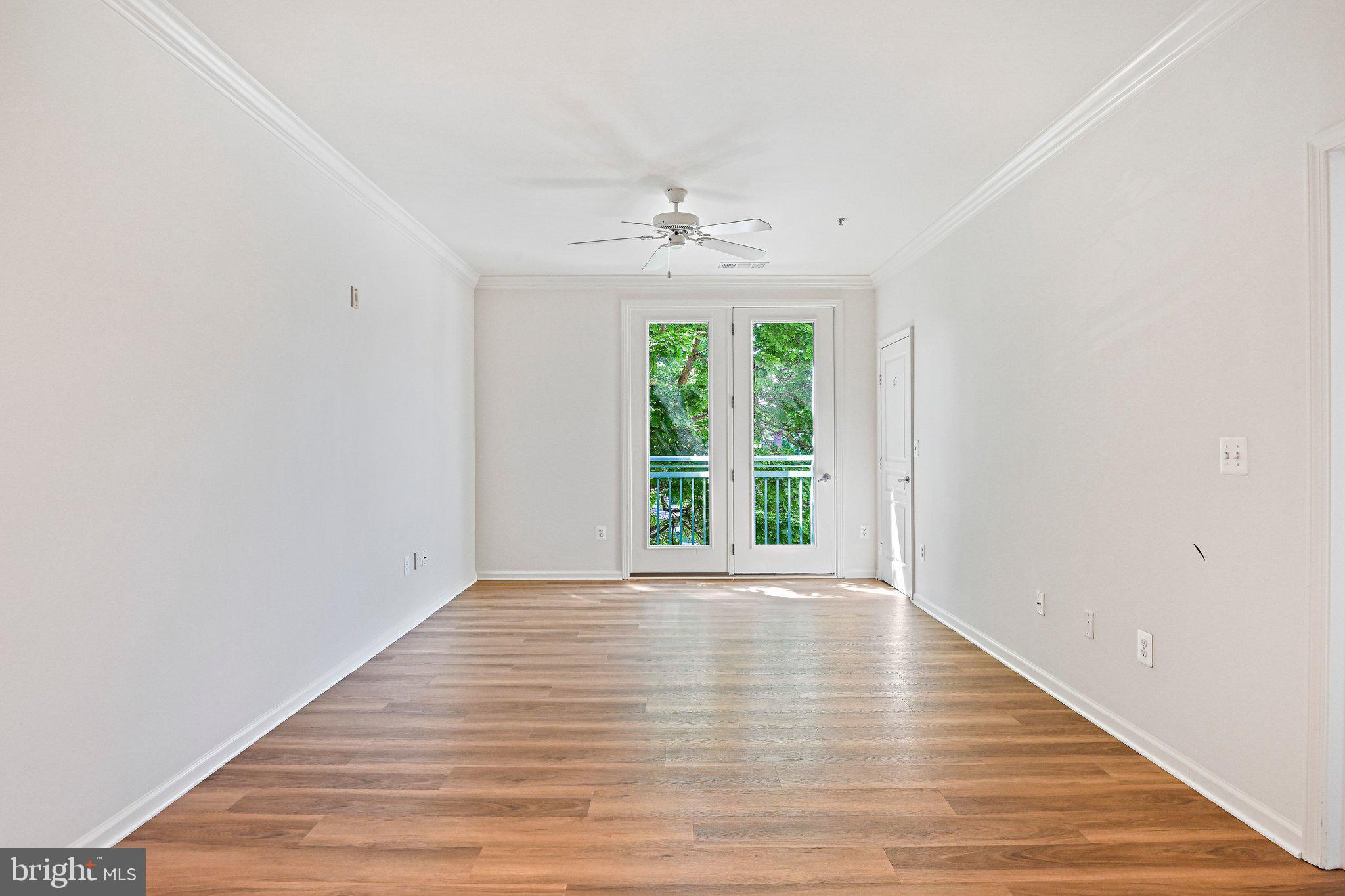 12001 Market Street, Unit 151 Reston, VA 20190 - Photo 8 of 25 wooden floor in an empty room with a window