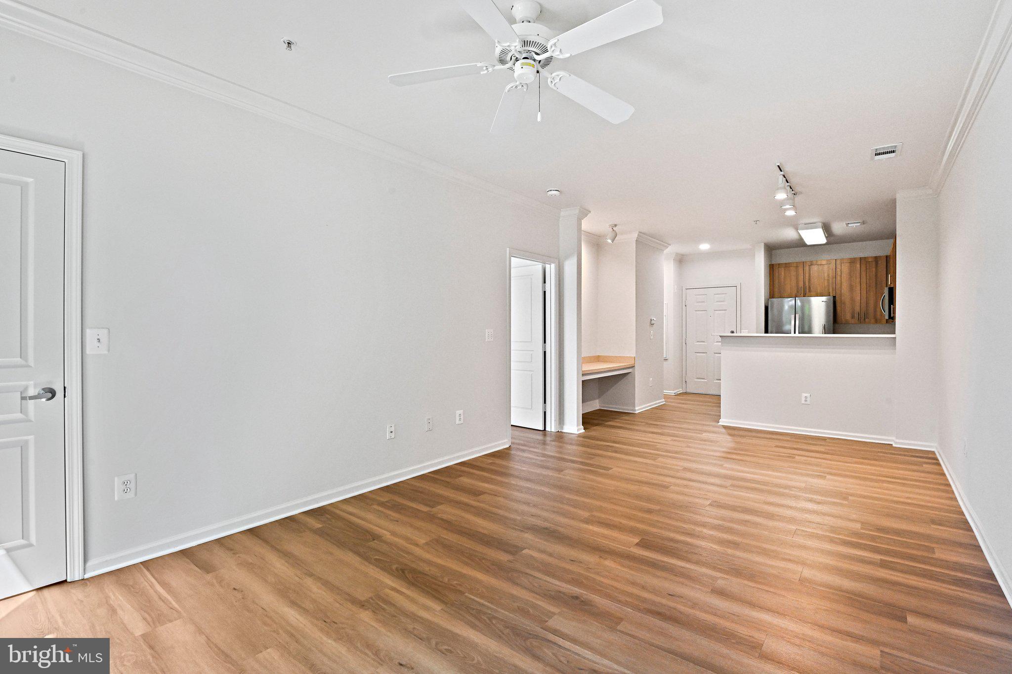 12001 Market Street, Unit 151 Reston, VA 20190 - Photo 9 of 25 a view of a kitchen with wooden floor and a kitchen