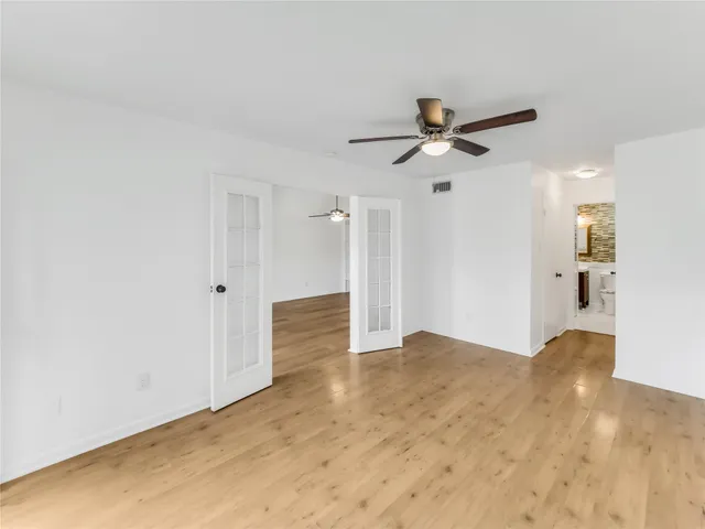 a room with a stove and a refrigerator