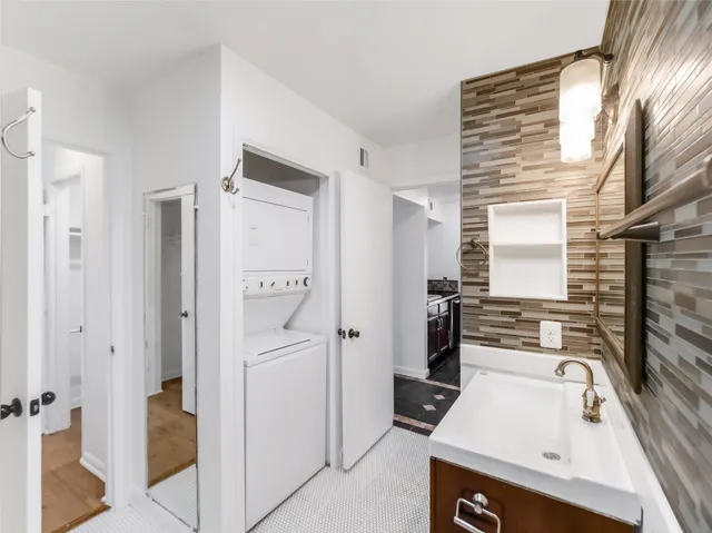 a bathroom with a bathtub shower sink mirror and toilet
