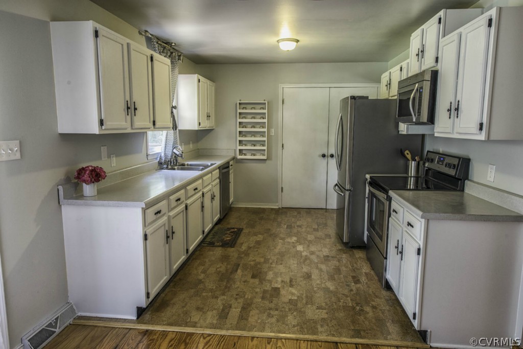 15176 Verdon Road Beaverdam, VA 23015 - Photo 6 of 15 a kitchen with stainless steel appliances a sink stove refrigerator and cabinets
