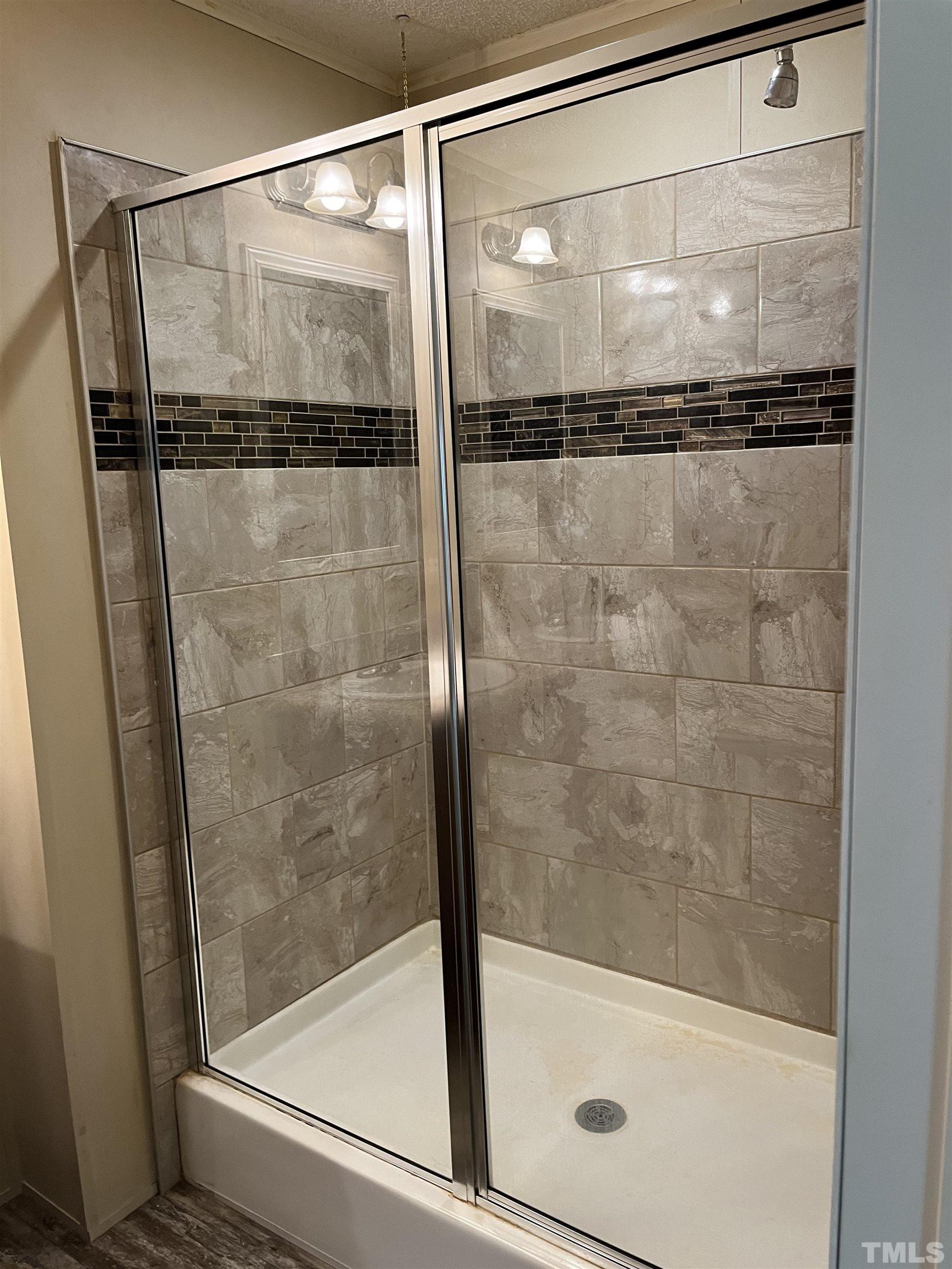 1620 Ridge Road Zebulon, NC 27597 - Photo 3 of 7 a bathroom with a glass shower door