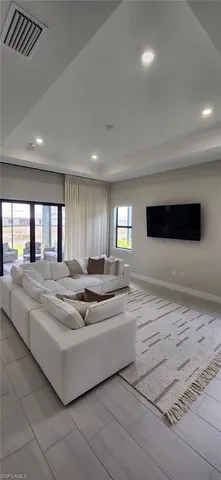 a living room with couch and a flat screen tv