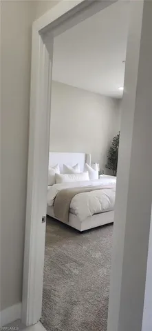 a large white kitchen with a sink and white appliances