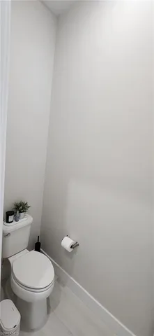 a white toilet sitting next to a white sink