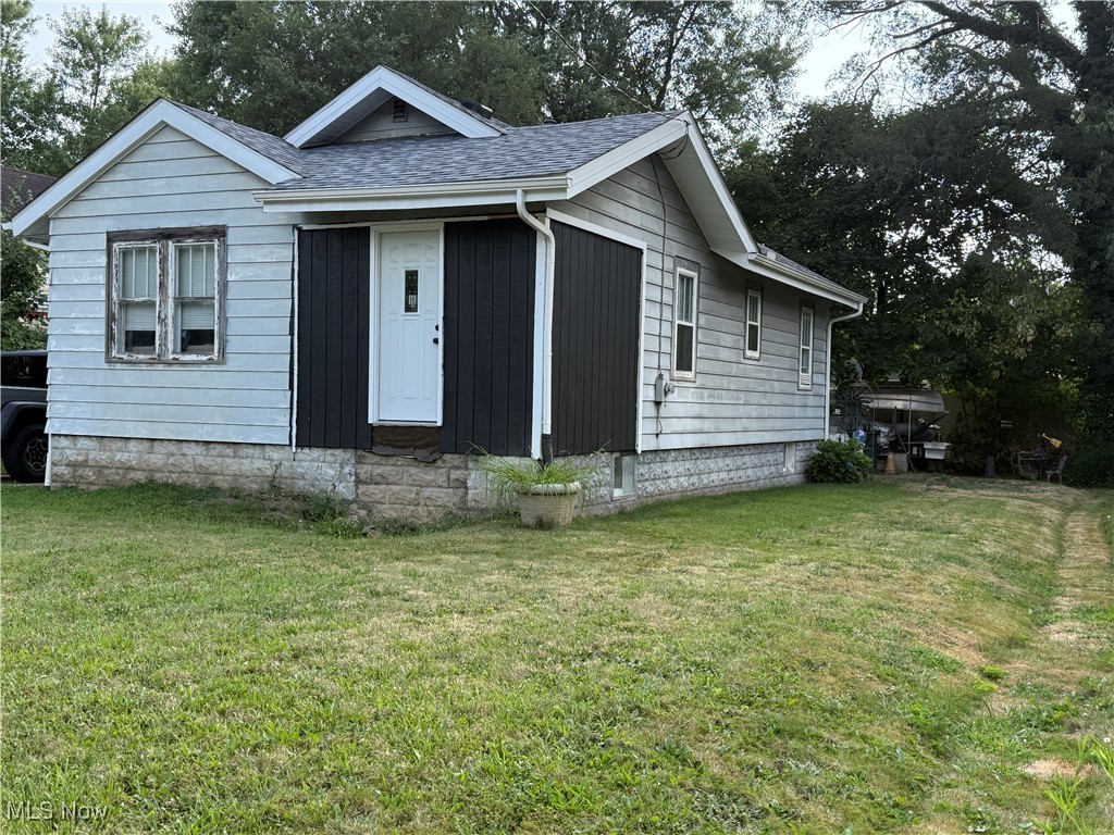 878 Brittain Road Akron, OH 44305 - Photo 2 of 16 View of front of home featuring a front lawn, a shingled roof, and entry steps