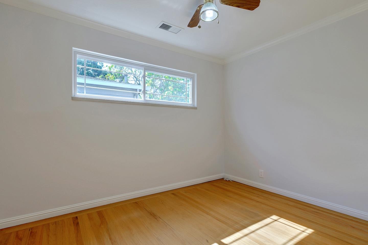 1228 Ruby Street Redwood City, CA 94061 - Photo 11 of 28 an empty room with a window