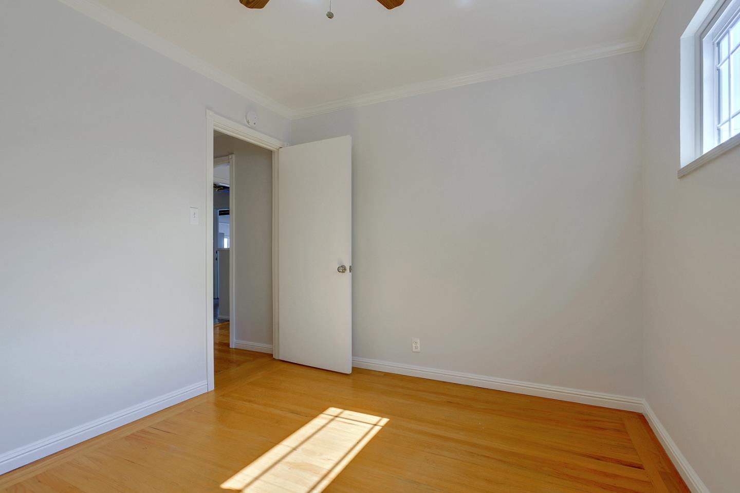 1228 Ruby Street Redwood City, CA 94061 - Photo 12 of 28 a view of a room with wooden floor and a window