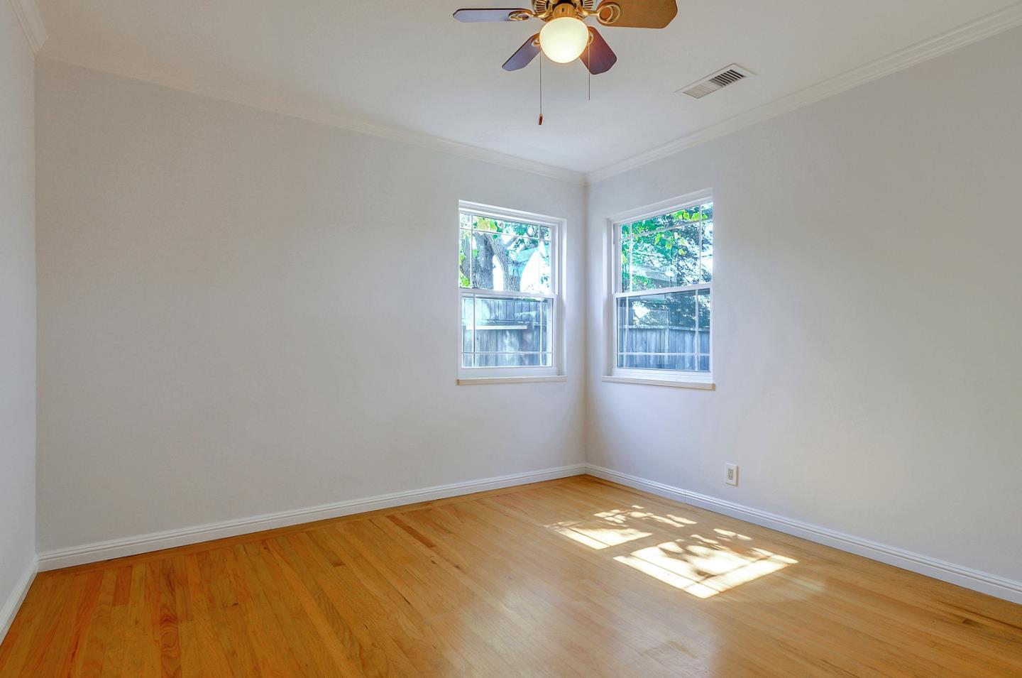 1228 Ruby Street Redwood City, CA 94061 - Photo 13 of 28 a view of a room with a window and ceiling fan