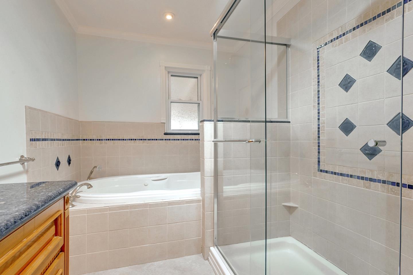 1228 Ruby Street Redwood City, CA 94061 - Photo 16 of 28 a bathroom with a bathtub and a shower