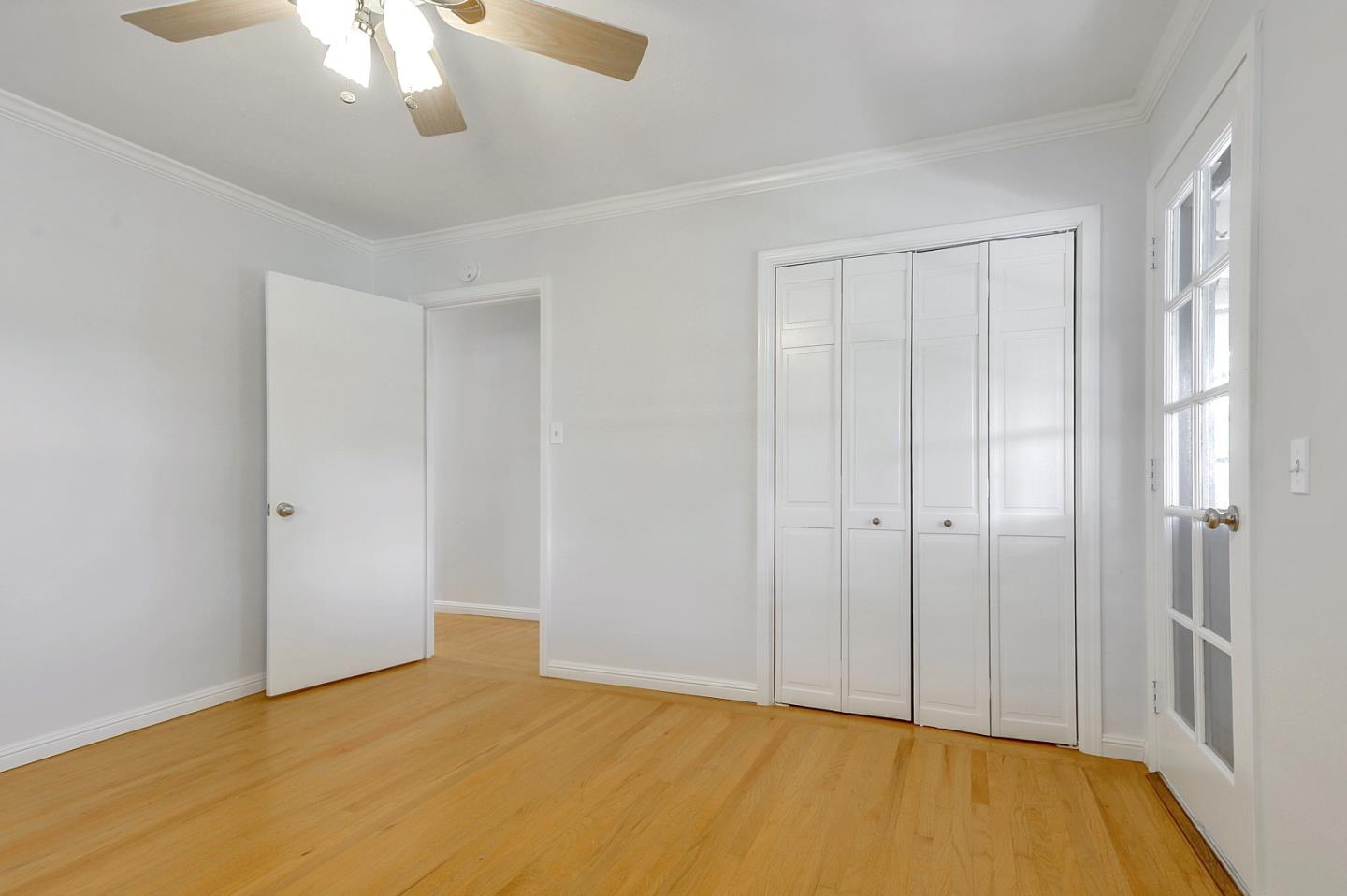 1228 Ruby Street Redwood City, CA 94061 - Photo 18 of 28 a view of an empty room with a chandelier fan