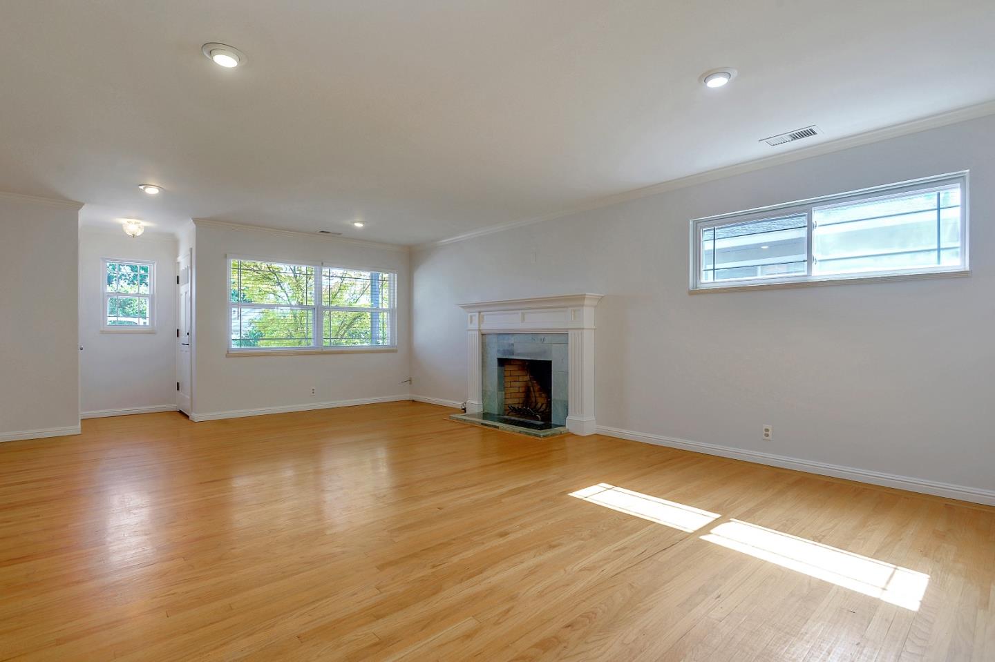 1228 Ruby Street Redwood City, CA 94061 - Photo 3 of 28 an empty room with windows and fireplace