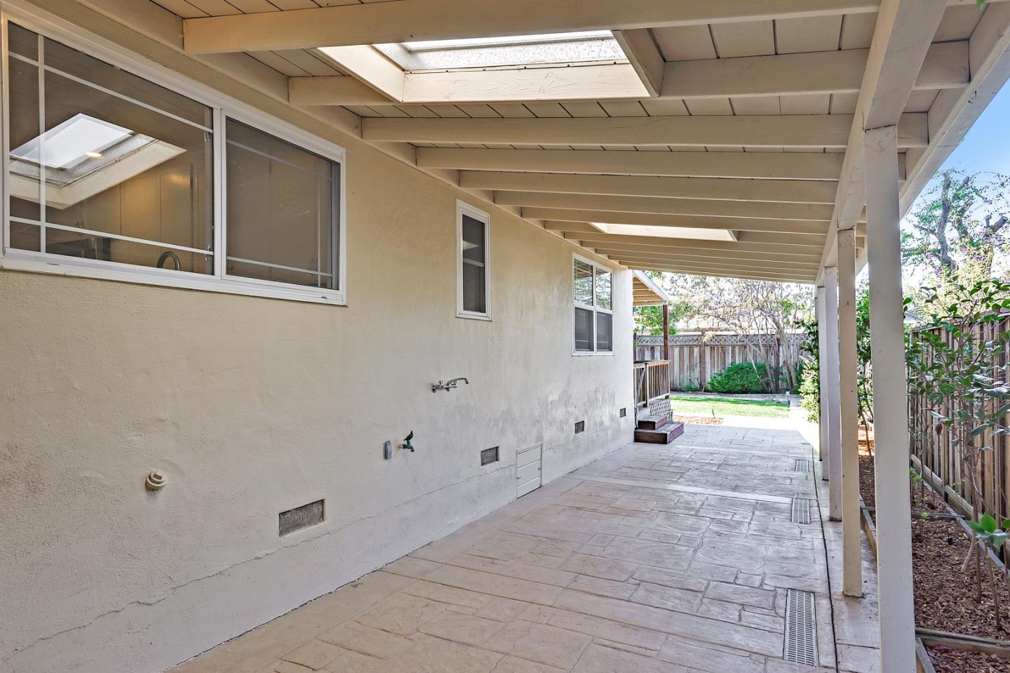 1228 Ruby Street Redwood City, CA 94061 - Photo 22 of 28 a view of a porch with wooden floor and fence
