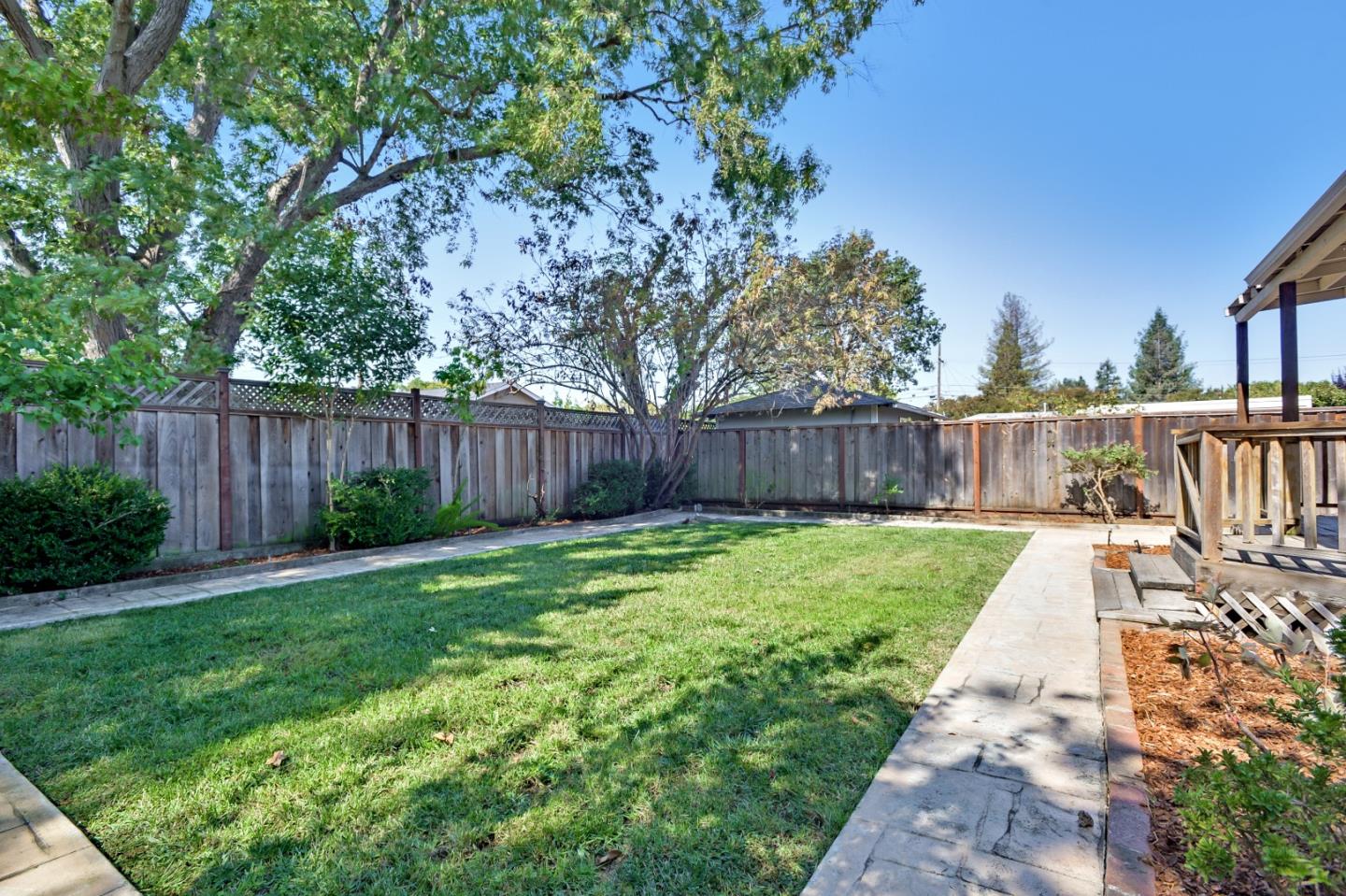1228 Ruby Street Redwood City, CA 94061 - Photo 28 of 28 a view of a yard with swimming pool and wooden fence