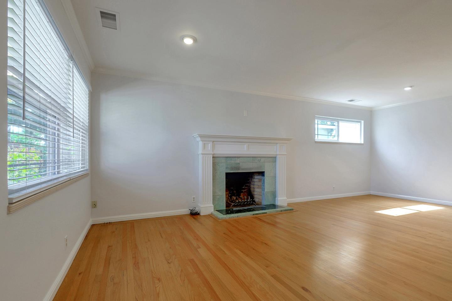 1228 Ruby Street Redwood City, CA 94061 - Photo 4 of 28 a view of empty room with wooden floor and fireplace