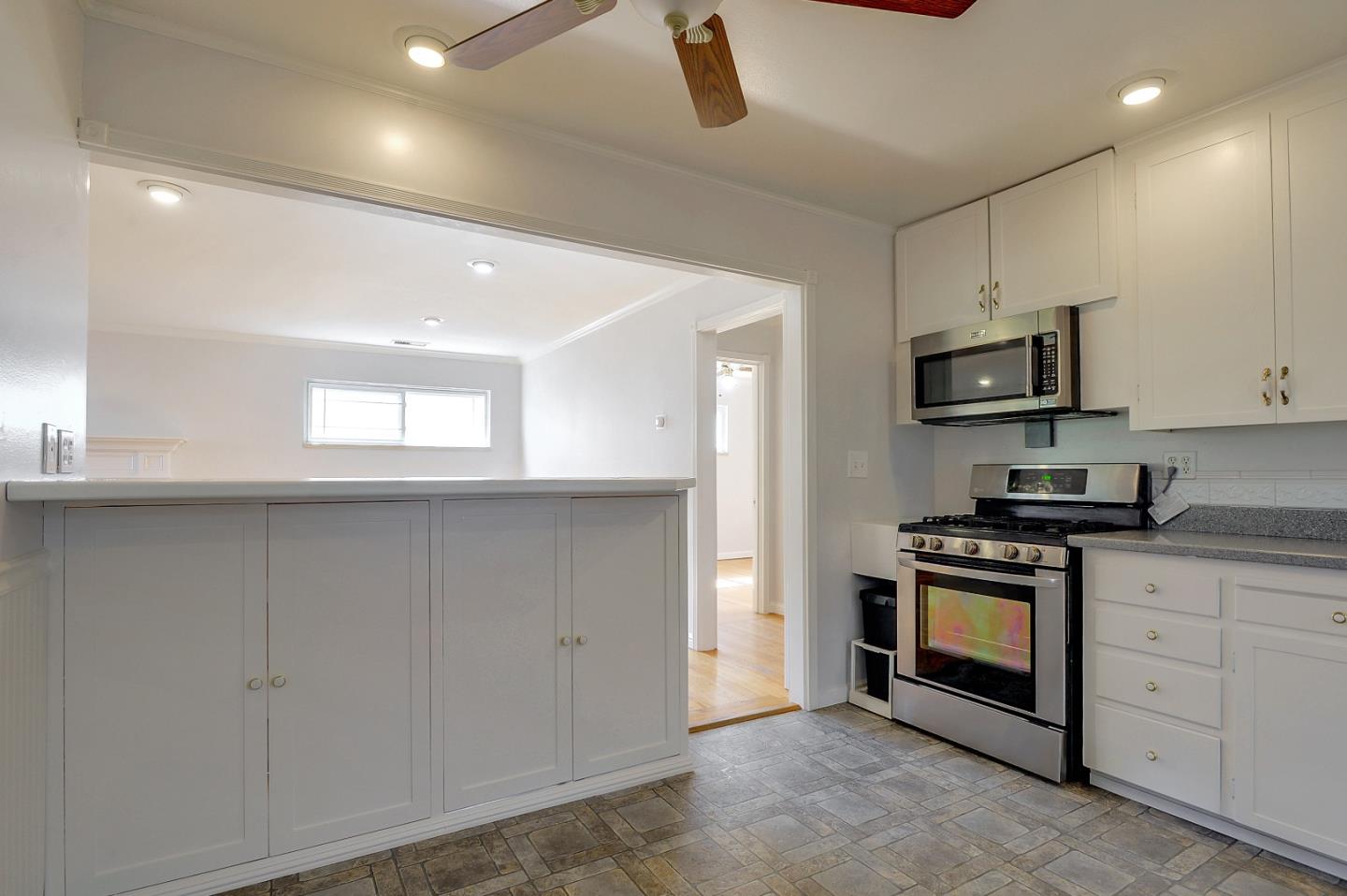 1228 Ruby Street Redwood City, CA 94061 - Photo 7 of 28 a kitchen with granite countertop white cabinets and stainless steel appliances