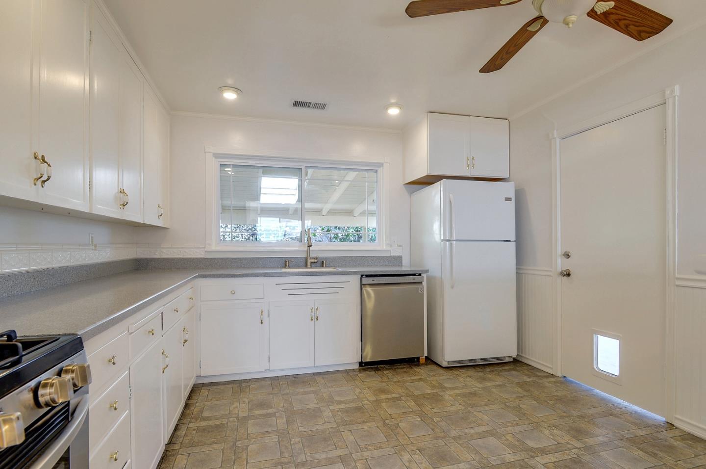 1228 Ruby Street Redwood City, CA 94061 - Photo 9 of 28 a kitchen with white cabinets and white appliances