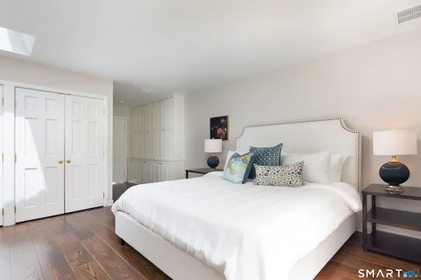 a bedroom with a bed and a night stand