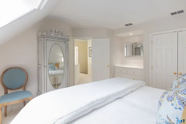 a bedroom with a bed and a dresser