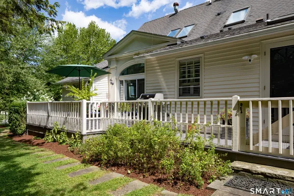 a view of a house with a small yard and wooden fence
