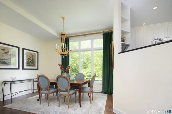 a dining room with furniture a chandelier and window