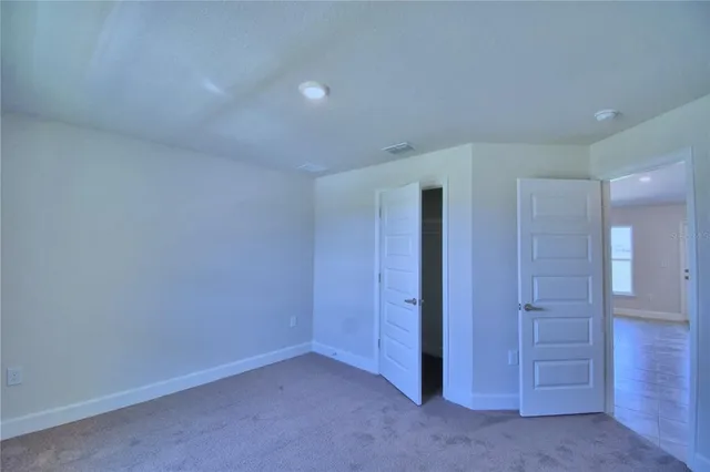an empty room with closet area