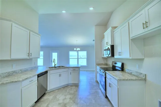 a kitchen with stainless steel appliances granite countertop a stove a sink and a granite counter tops