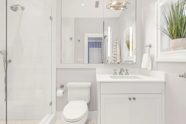 a bathroom with a toilet a sink and a mirror