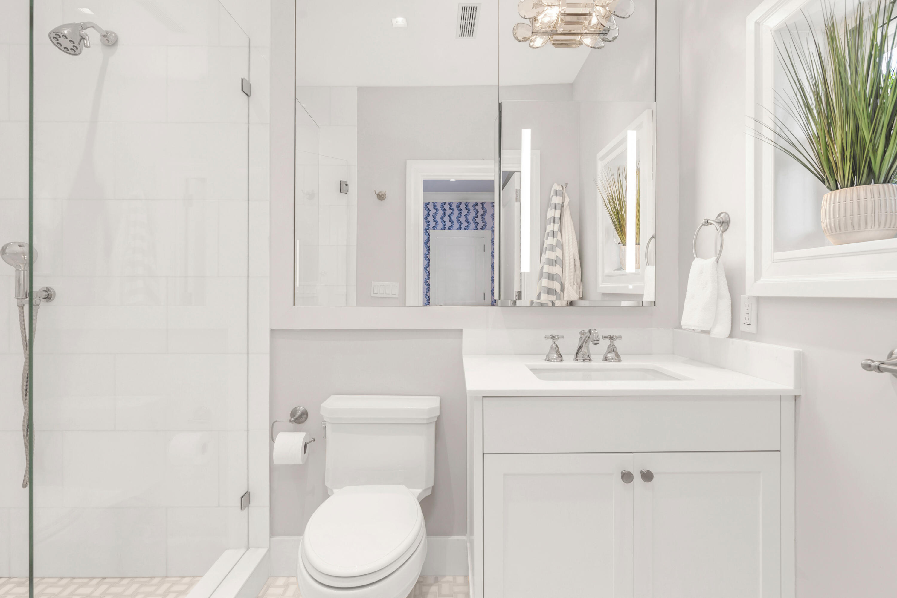 146 Sunset Avenue, Unit C Palm Beach, FL 33480 - Photo 12 of 18 a bathroom with a toilet a sink and a mirror