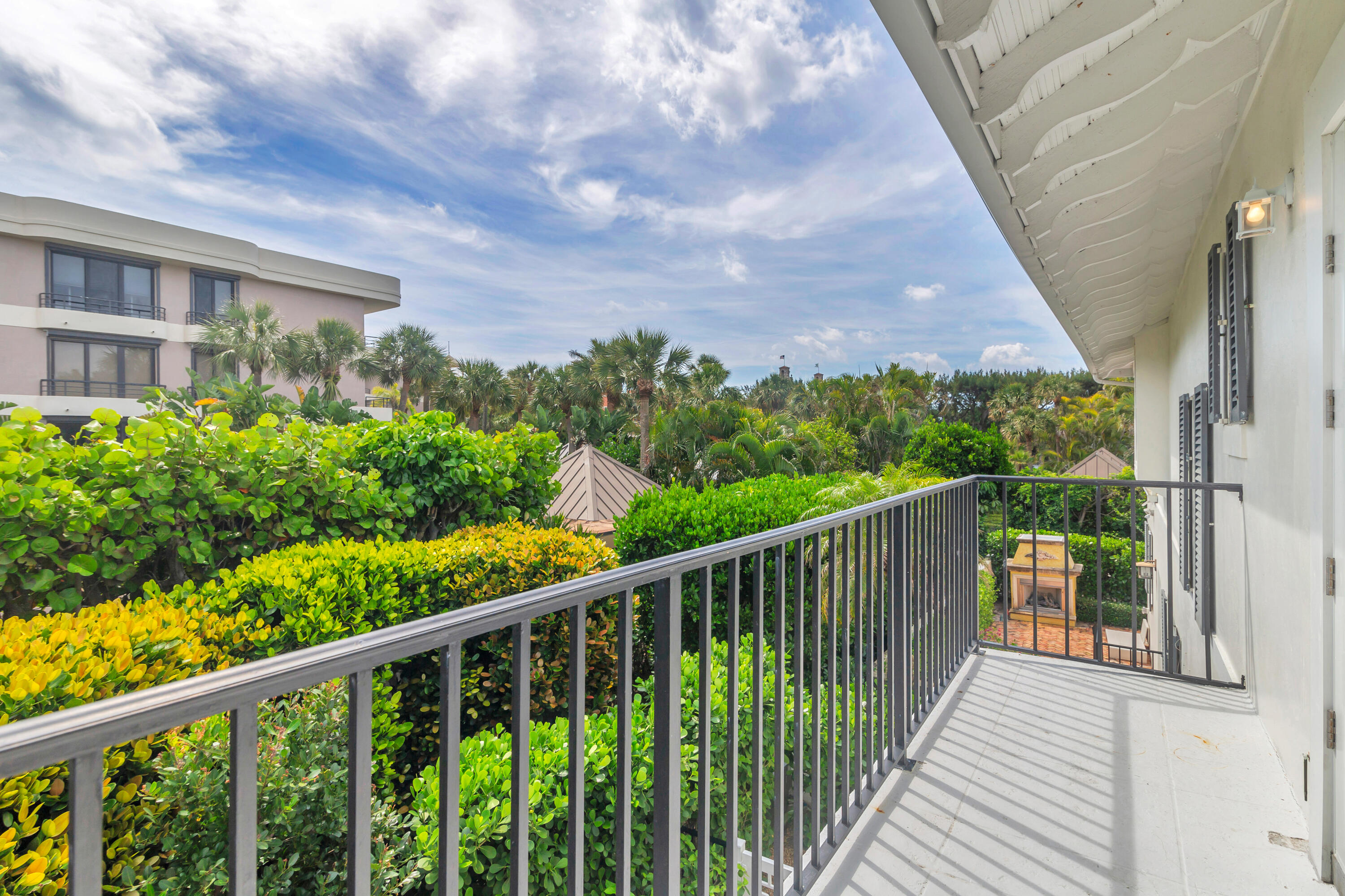 146 Sunset Avenue, Unit C Palm Beach, FL 33480 - Photo 13 of 18 a balcony with trees in front of it