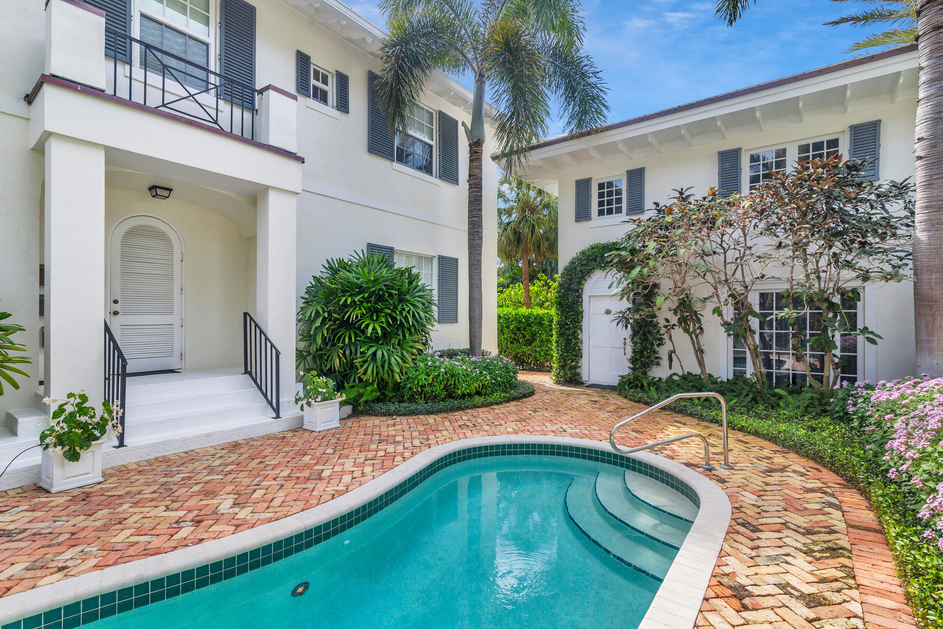 146 Sunset Avenue, Unit C Palm Beach, FL 33480 - Photo 2 of 18 a front view of a house with garden