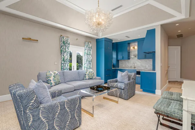 a living room with furniture and a chandelier