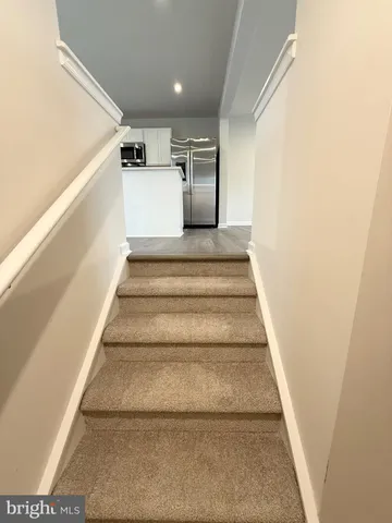 a view of kitchen with cabinets and wooden floor
