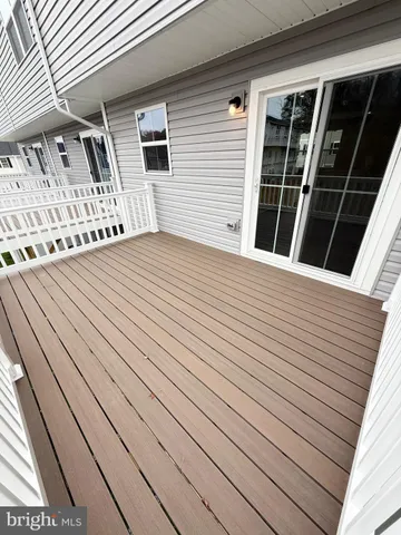 a view of a house with wooden deck