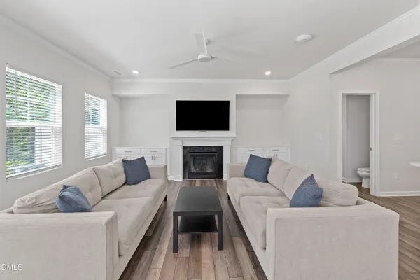 a living room with furniture a fireplace and a flat screen tv