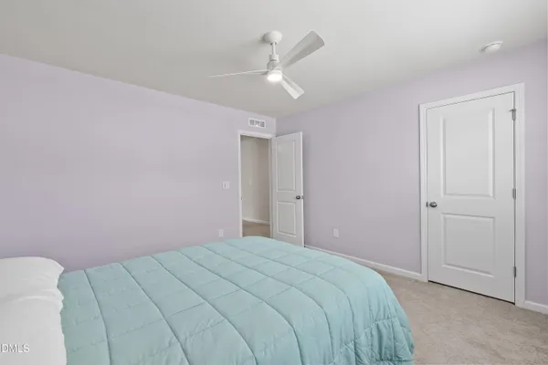a bedroom with a bed and a ceiling fan