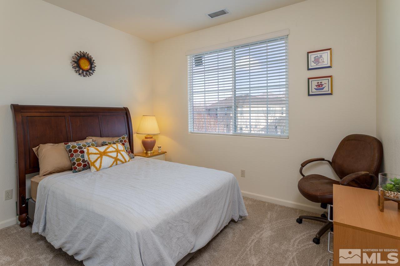 11046 Lamour Lane Reno, NV 89521 - Photo 13 of 19 a bedroom with a bed and with windows