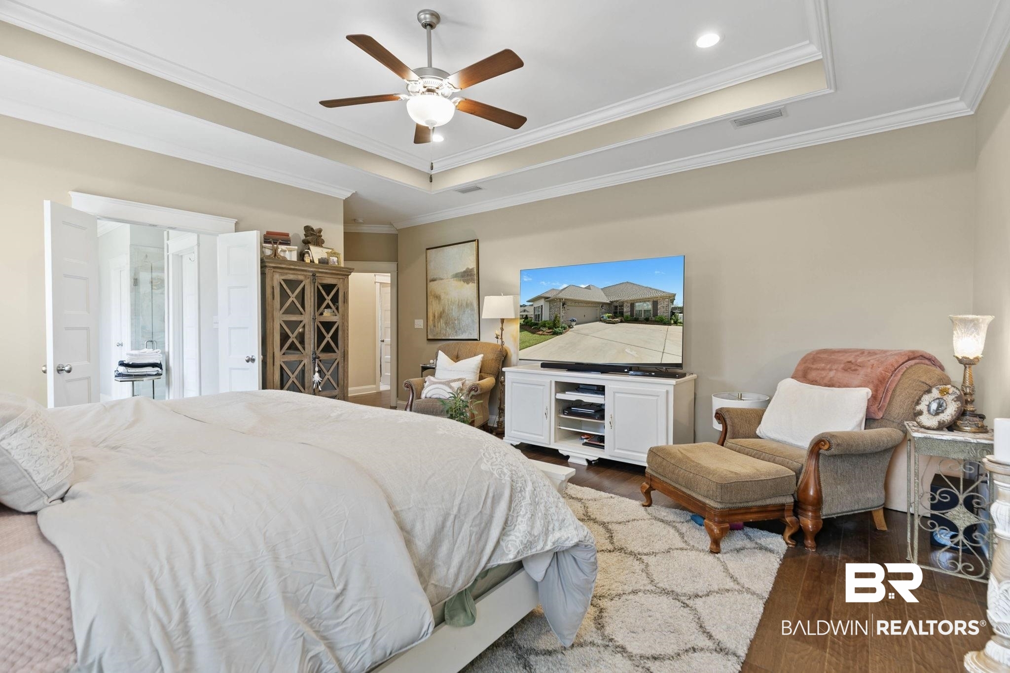 291 Hemlock Drive Fairhope, AL 36532 - Photo 30 of 65 Bedroom with wood-type flooring, crown molding, a ceiling fan, and a raised ceiling