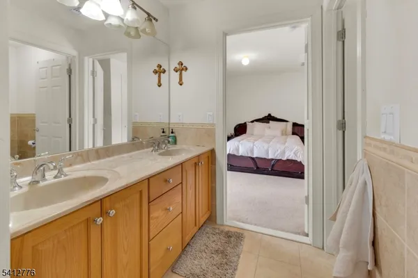 a en suite bathroom with a double sink and mirror