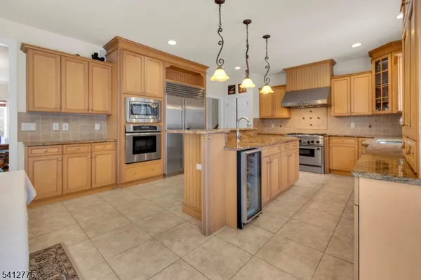 a large kitchen with cabinets and stainless steel appliances