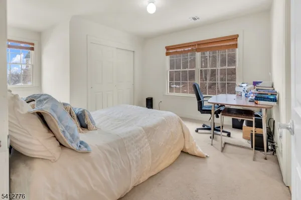 a bedroom with a bed and a desk