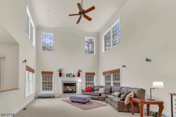 a living room with furniture a fireplace and a window