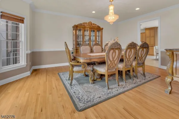 a dining room with furniture a chandelier and wooden floor