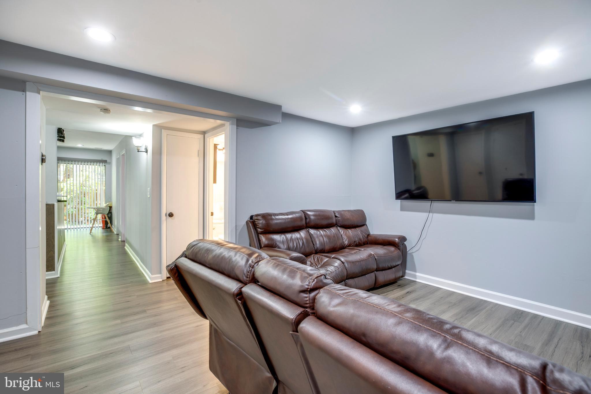 3382 Hewitt Avenue, Unit 102 Silver Spring, MD 20906 - Photo 13 of 22 a living room with furniture and a flat screen tv