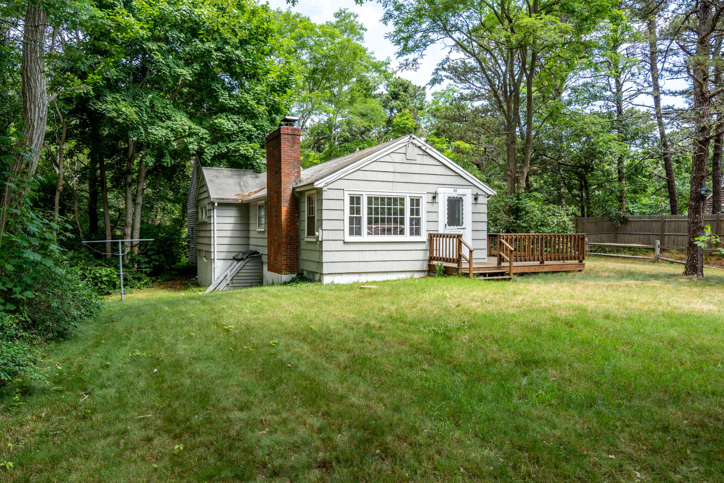 66 Pilgrim Spring Road Wellfleet, MA 02667 - Photo 1 of 21 a front view of a house with garden