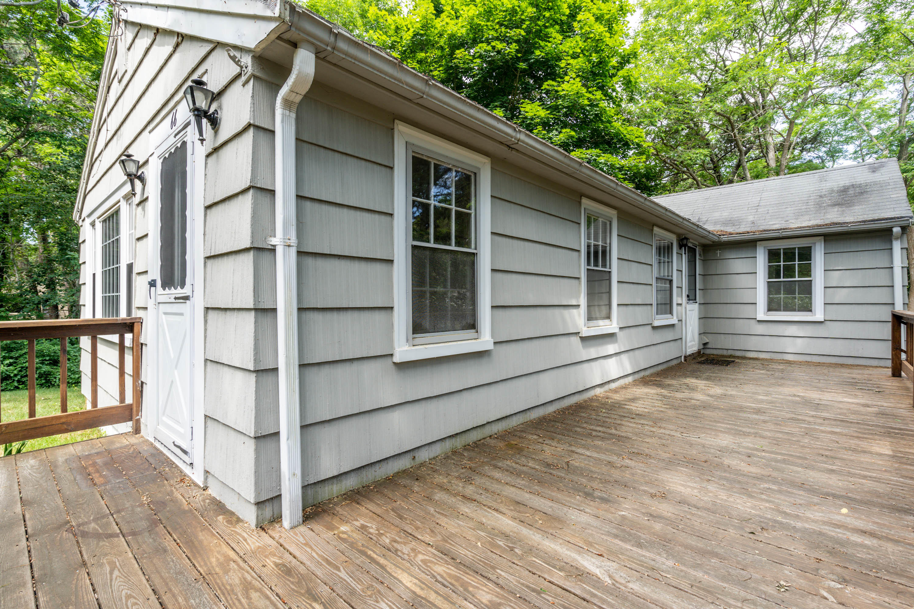66 Pilgrim Spring Road Wellfleet, MA 02667 - Photo 3 of 21 a view of a house with a large window and wooden fence