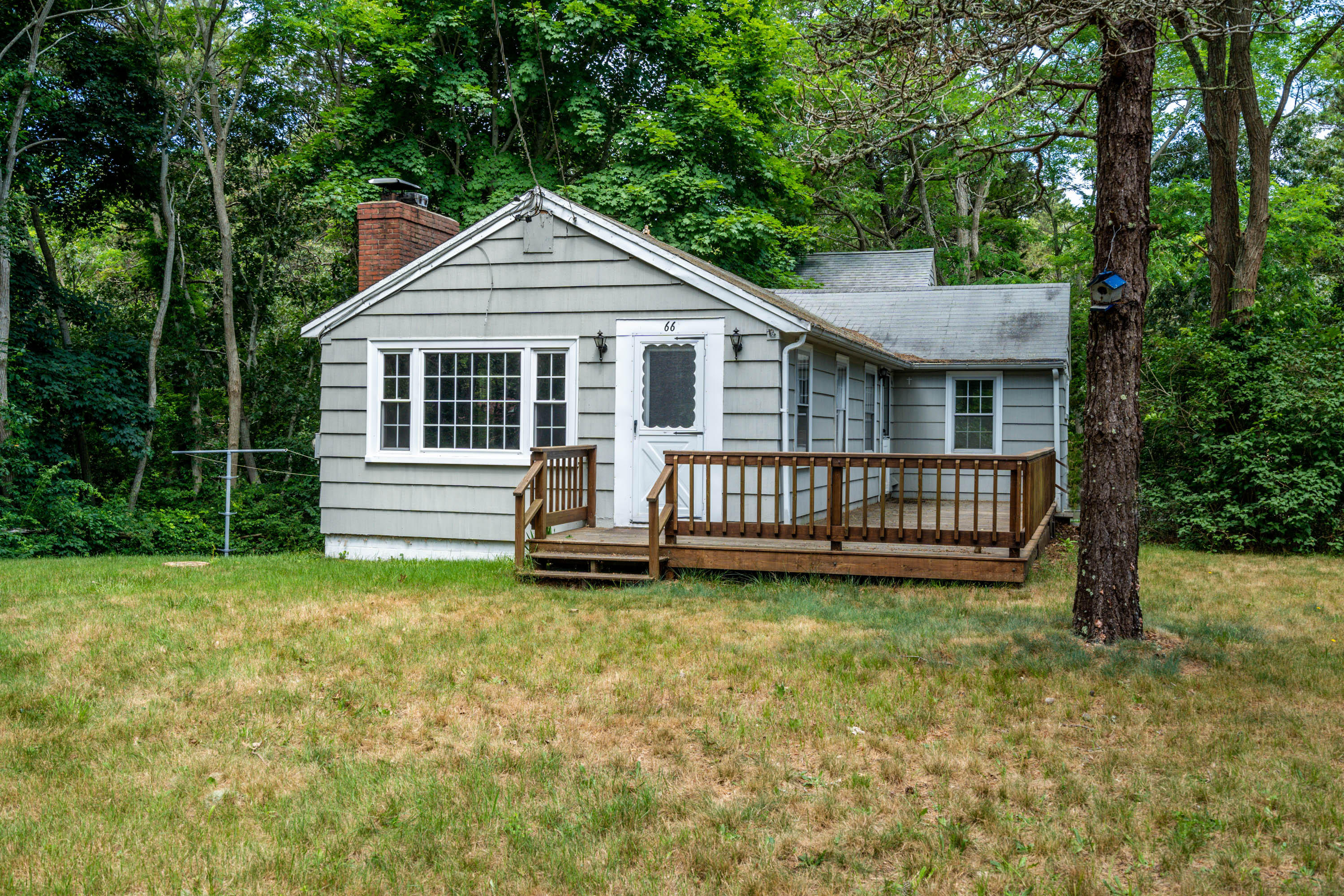 66 Pilgrim Spring Road Wellfleet, MA 02667 - Photo 6 of 21 a view of a house with a yard and deck