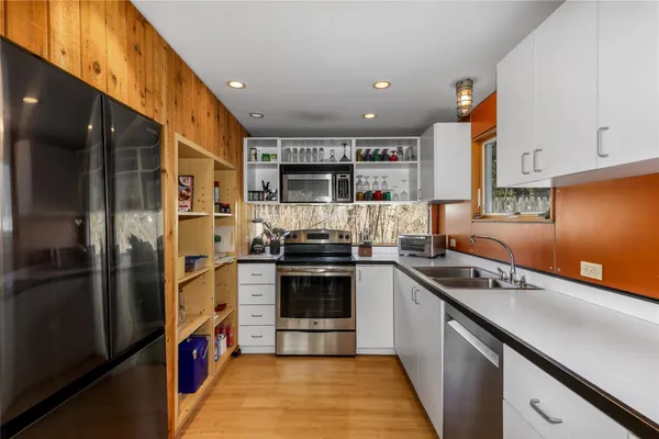 a kitchen with stainless steel appliances granite countertop a stove and a refrigerator