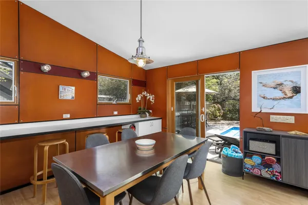 a view of a dining room with furniture a chandelier and wooden floor