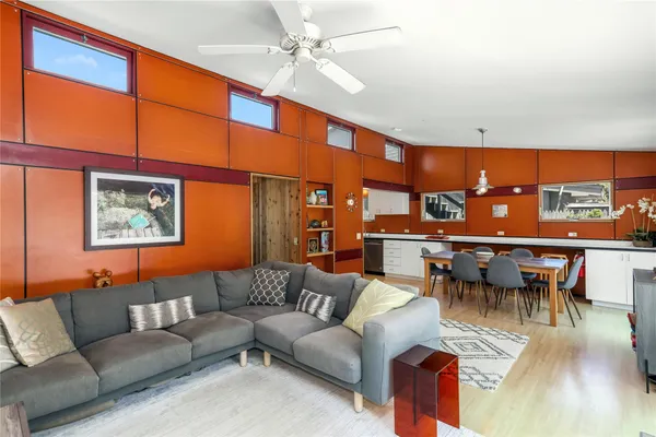 a living room with furniture a ceiling fan and a rug